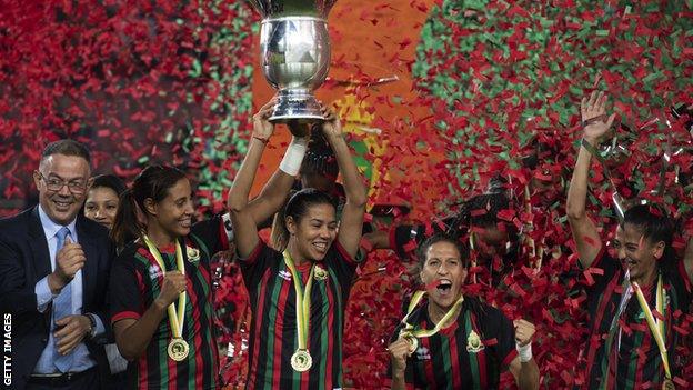 AS FAR players lift the Women's African Champions League trophy