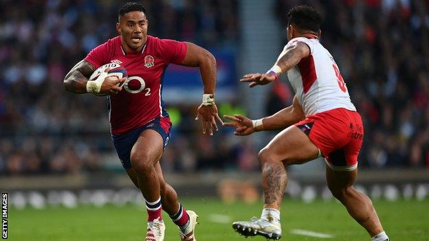 Manu Tuilagi runs with the ball against Tonga