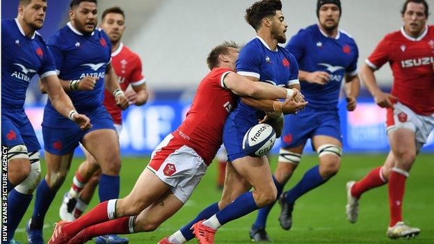 France outside-half Romain Ntamack tackled in full flight