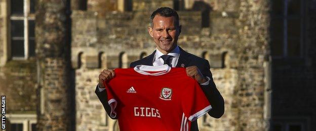 Ryan Giggs posing with a Wales shirt on the day he was unveiled