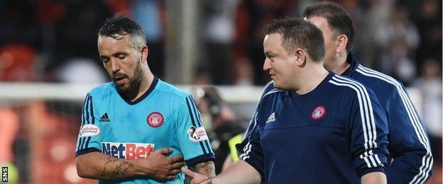 Dougie Imrie (left) leaves the field holding a rib injury