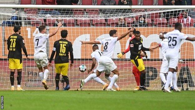 Augsburg celebrate the opening goal against Borussia Dortmund on Saturday