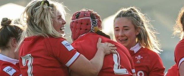 Wales players celebrate a try by hooker Carys Phillips