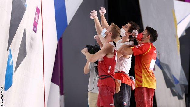 Competitors assess the wall during the Sport Climbing men's final