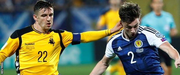 Lithuania's Fedor Chernykh tackles Scotland's Kieran Tierney (right)