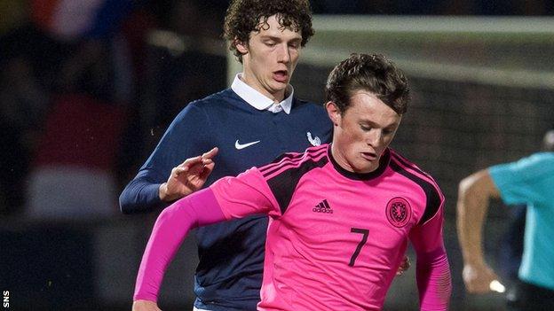 Liam Henderson steers away from France's Benjamin Pavard