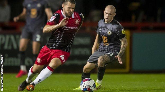 Jake Reeves takes the ball away from Newport's James Waite