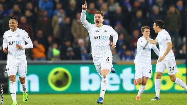 Swansea City defender Alfie Mawson (centre) celebrates scoring against Leicester City