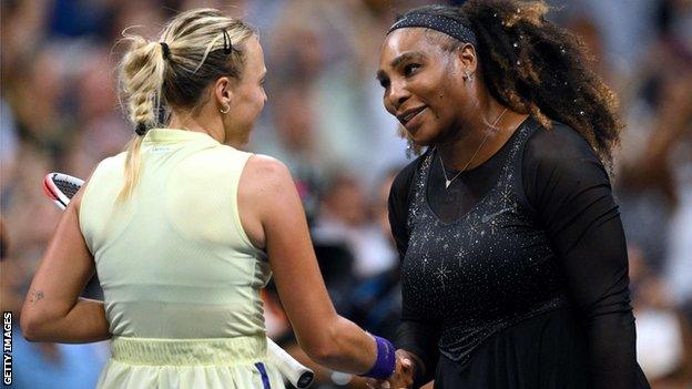 Serena Williams shakes hands with Anett Kontaveit at the net after their US Open match