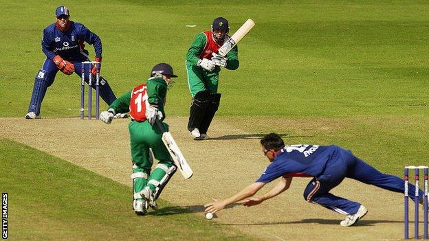 Mark Wallace of Wales steers the ball past England's Ashley Giles of England in a friendly in 2003 at Sophia Gardens