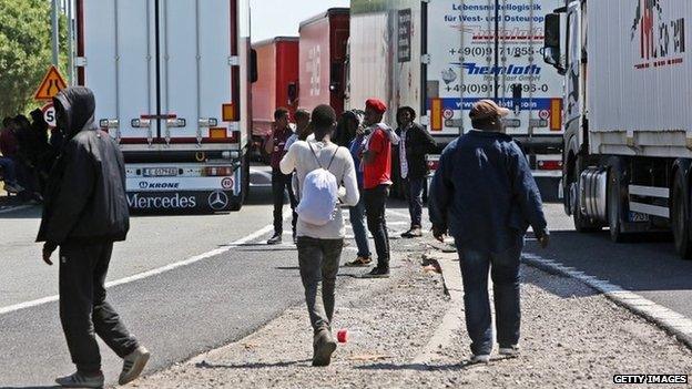 Migrants near trucks heading to the UK