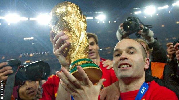 Andres Iniesta celebrates with the World Cup trophy after Spain's triumph in 2010