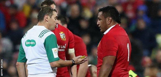 Jerome Garces, the referee, talks to Lions prop Mako Vunipola during the match between the New Zealand All Blacks and the British & Irish Lions