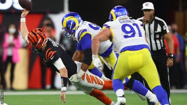 Joe Burrow is tackled by Aaron Donald