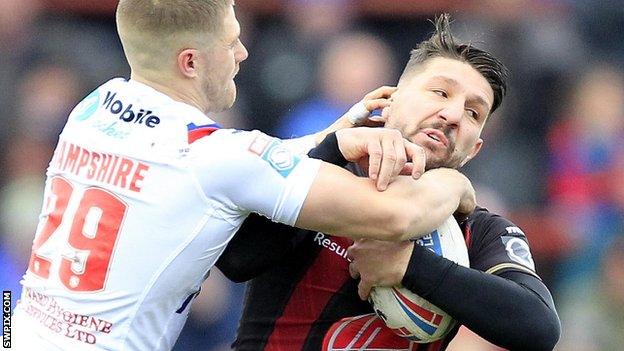 Wakefield's Ryan Hampshire tackles Warrington's Gareth Widdop