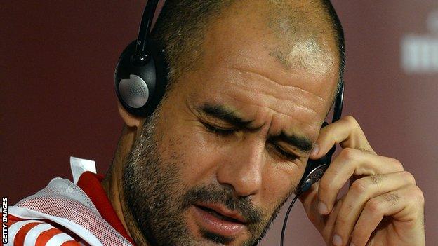 Pep Guardiola listens to headphones