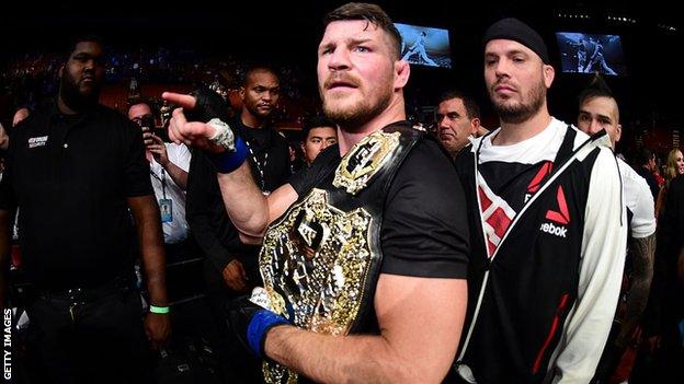 Michael Bisping points with his UFC title