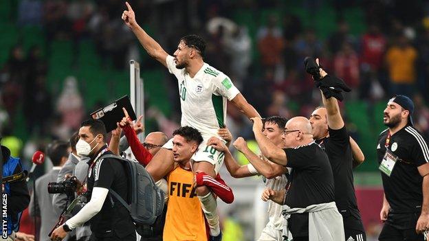 Algeria's Youcef Belaili on his team-mates shoulders