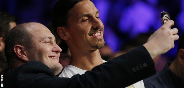 Manchester United striker Zlatan Ibrahimovic stops for a selfie ringside