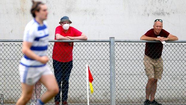 Two supporters watch a recent GAA match