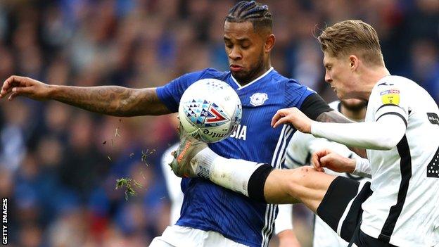 Leandro Bacuna of Cardiff City and Swansea City's George Byers battle for possession