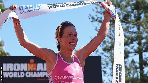 Holly Lawrence celebrates winning the half ironman 70.3 World Championship