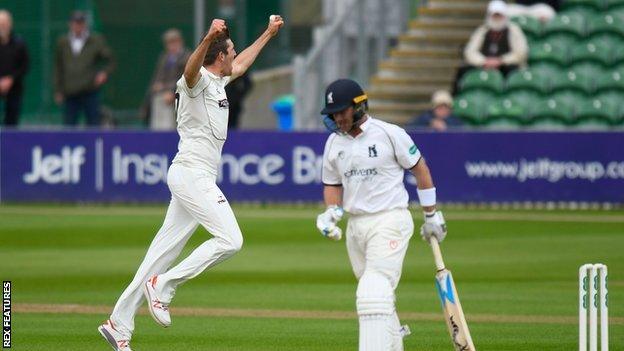 Craig Overton celebrates taking the wicket of Ian Bell