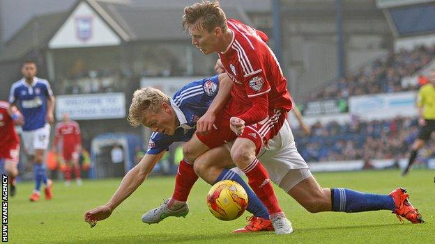 Joe Mason of Cardiff is fouled by Jonathan Parr of Ipswich