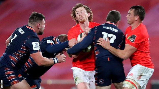 Munster fly-half Ben Healy is halted by Edinburgh's Mark Bennett