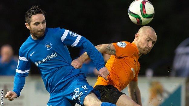 Ballinamallard's Jay McCartney and Carrick midfielder Barry Johnston tussle for the ball