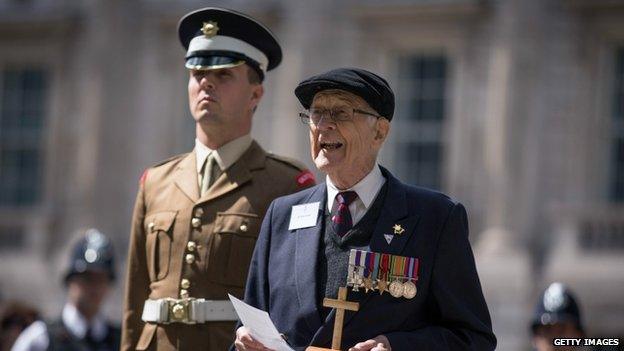 Burma Star Veteran Richard De Renzy Channer reads a poem at the statue of Field Marshall Slim (commander of the 14th Army in Burma) after laying a wreath during the 70th Anniversary commemorations of VJ Day (Victory over Japan) on August 15, 2015 in London, England.