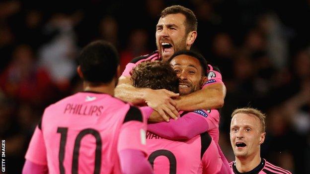 James McArthur (top) celebrates with Scotland against Slovenia