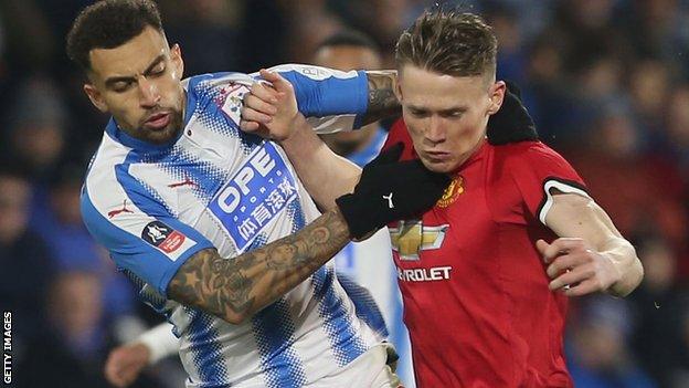 Danny Williams of Huddersfield Town challenges Scott McTominay of Manchester United