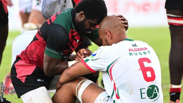 Kenya's Jone Kubu Tavaga consoles Algeria's Marvyn Youcef