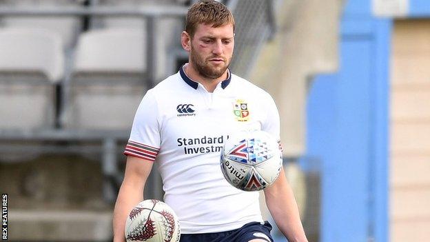 Finn Russell shows off his skills with a football and a rugby ball