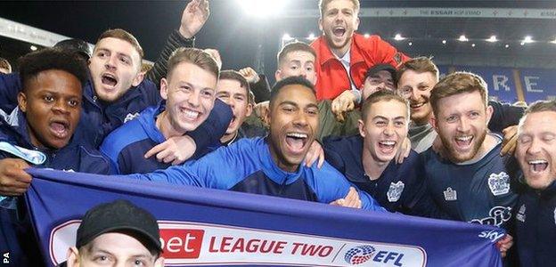 Bury celebrate promotion from League Two following their draw against Tranmere in April