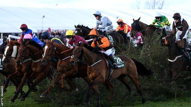 Horses in the 2022 Grand National clear one of the fences