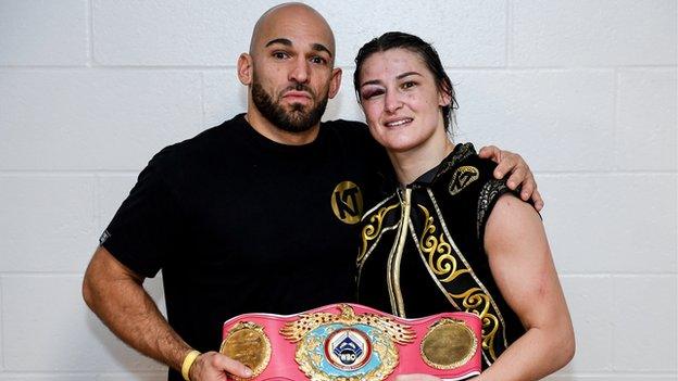 Katie Taylor (right) poses with trainer Ross Enamait and the WBO super-lightweight belt