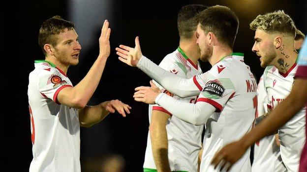 Paul Mullin celebrates with team mates after scoring against Weymouth