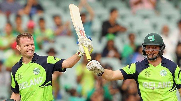 William Porterfield celebrates a century at the 2015 World Cup with Gary Wilson