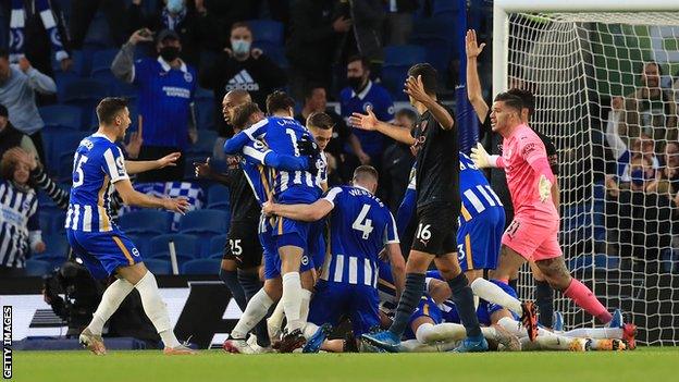 Brighton players celebrate Dan Burn's winning goal