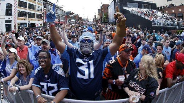 American football fans pack Broadway Street in Nashville