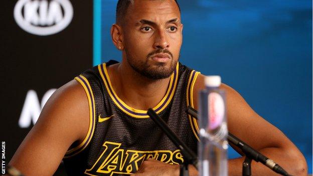 Nick Kyrgios wearing an LA Lakers shirt in a post-match news conference