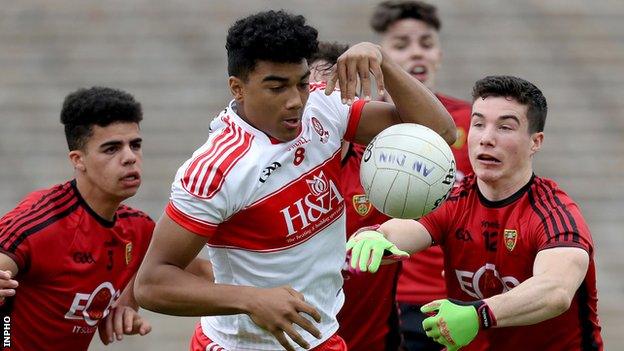 Derry forward Callum Brown attempts to move clear of Down pair Finn McIlroy and Daniel Guinness