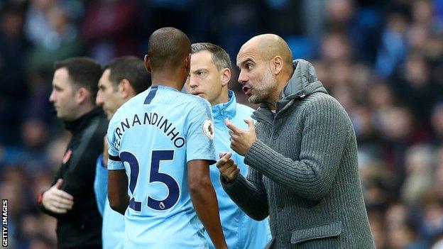 Pep Guardiola (right) issues instructions to Fernandinho