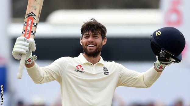 England wicketkeeper Ben Foakes celebrates his maiden Test century by raising his bat and helmet in the first Test against Sri Lanka in Galle