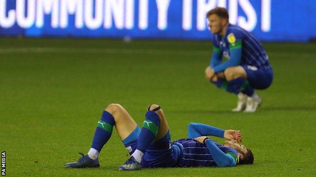 Dejected Wigan players