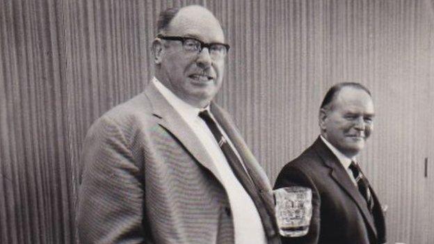 Two men holding beer