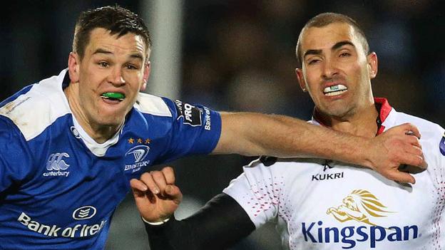 Leinster fly-half Jonny Sexton tussles with Ulster's Ruan Pienaar during the Pro12 derby at the RDS