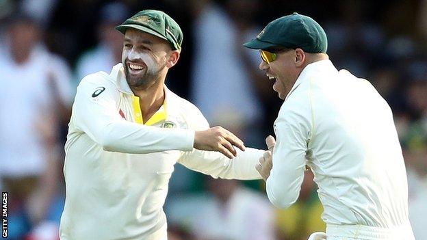 Australia's Nathan Lyon celebrates with David Warner